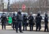 UK Terror Probe Points Straight To Iran Group of police officers in riot gear standing on a street; Brian Folkerts present