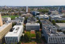 Alabama Campus Rocked By Trump Threat Busts aerial view of a university campus quad with surrounding academic buildings