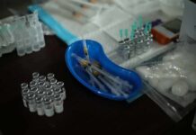 Medical syringes and vials arranged on a table