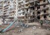 Kyiv High-Rise Inferno After Drone Blitz Damaged apartment building behind a playground slide