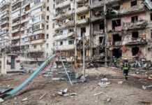Kyiv High-Rise Inferno After Drone Blitz Damaged apartment building behind a playground slide