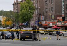 Gunfire Erupts At Packed Homecoming Stadium Police investigate a taped-off urban street crime scene