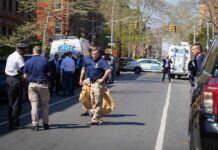 Hate Crime Fears Grip Fifth Avenue Police officers and investigators at a blocked city street scene