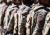 Soldiers in camouflage uniforms standing in formation