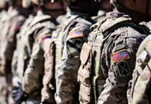 War With Iran Triggers Pay Jolt Soldiers in camouflage uniforms standing in formation