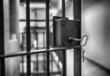 Judge Drops Hammer In Smuggling Deaths Jail cell door with key in the lock