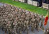 Pete Hegseth Slashes Generals – What’s Next? Soldiers in camouflage uniforms march in formation on a street