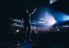 Country Star BLASTS Columbus – Backlash Explodes Singer on stage facing a large concert crowd