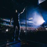 Country Star BLASTS Columbus – Backlash Explodes Singer on stage facing a large concert crowd