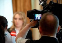 Trump Halts Livestream, Firing Squad Stays tv camera films interview with blurred speaker