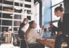 Wall Street Jumps on SpaceX Surprise Coworkers collaborating at a desk in a modern office