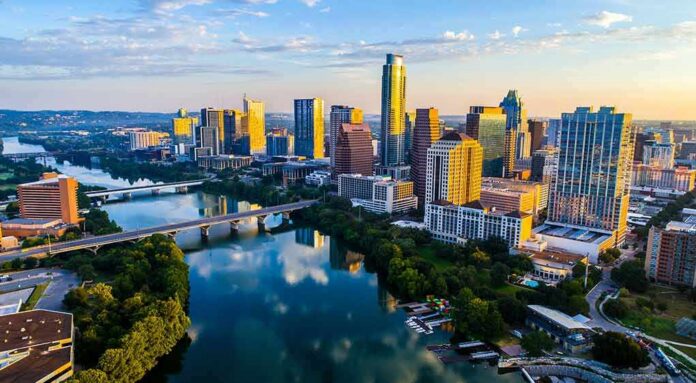 Skyline of a modern city with river and bridges at sunrise